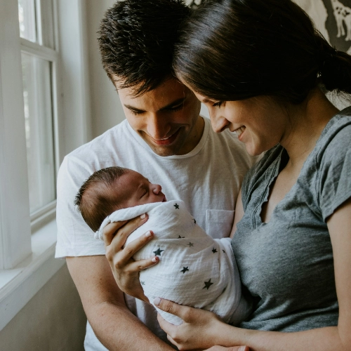 Familie mit Baby symbolisiert rechtliche Sicherheit bei Adoption